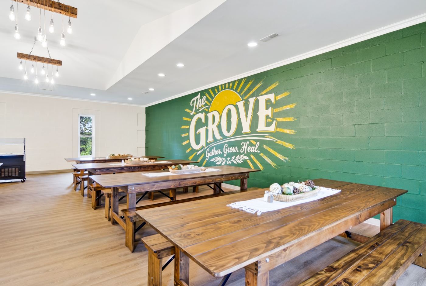 The Grove dining hall with long farmhouse tables and benches